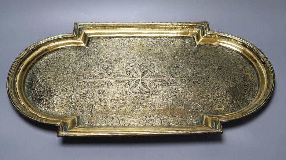 A 19th century Middle - Eastern engraved brass tray, 53cm wide